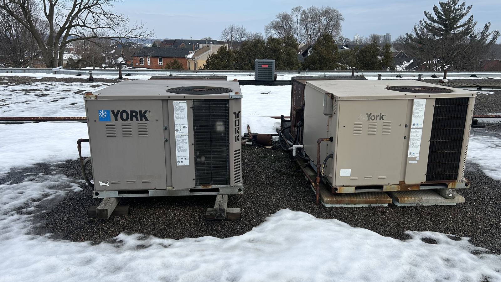 Ageing rooftop packaged units on a commercial roof